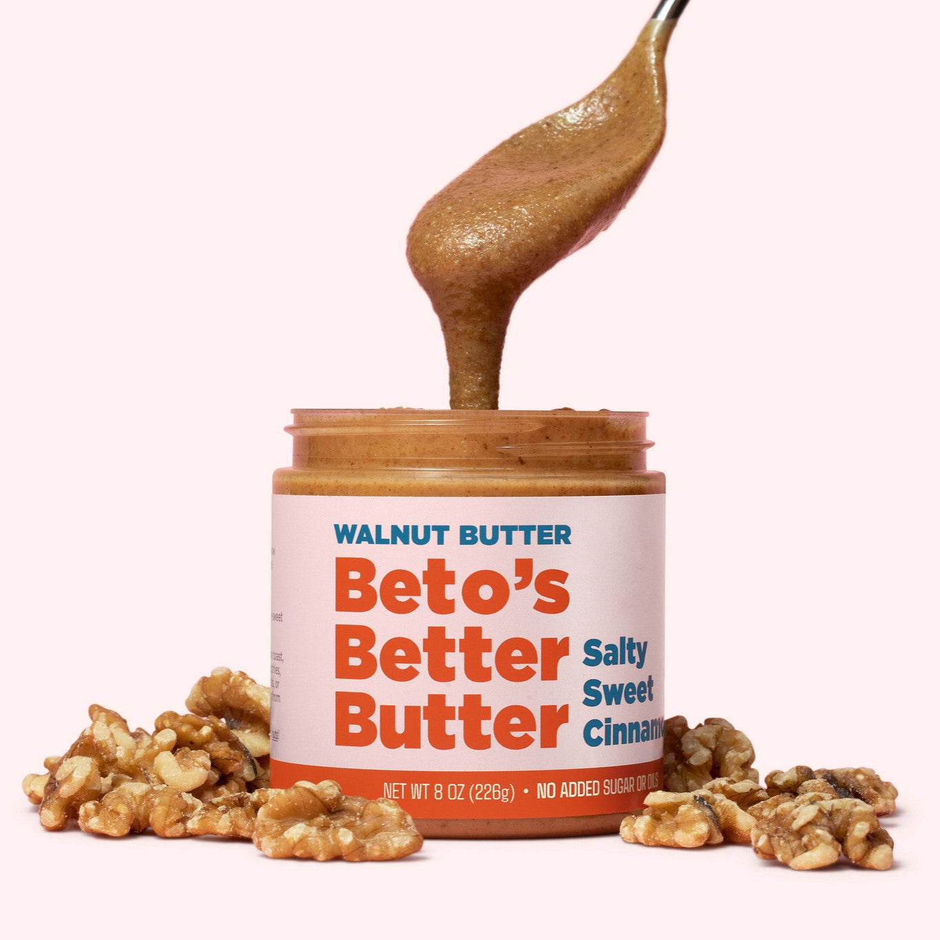 Beto's Better Butter with a spoon and walnuts